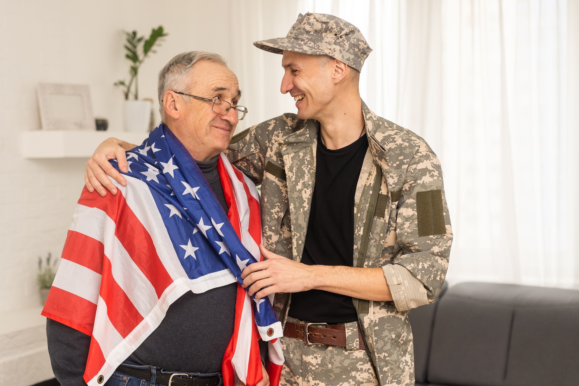 an elderly father and a military son, American flag