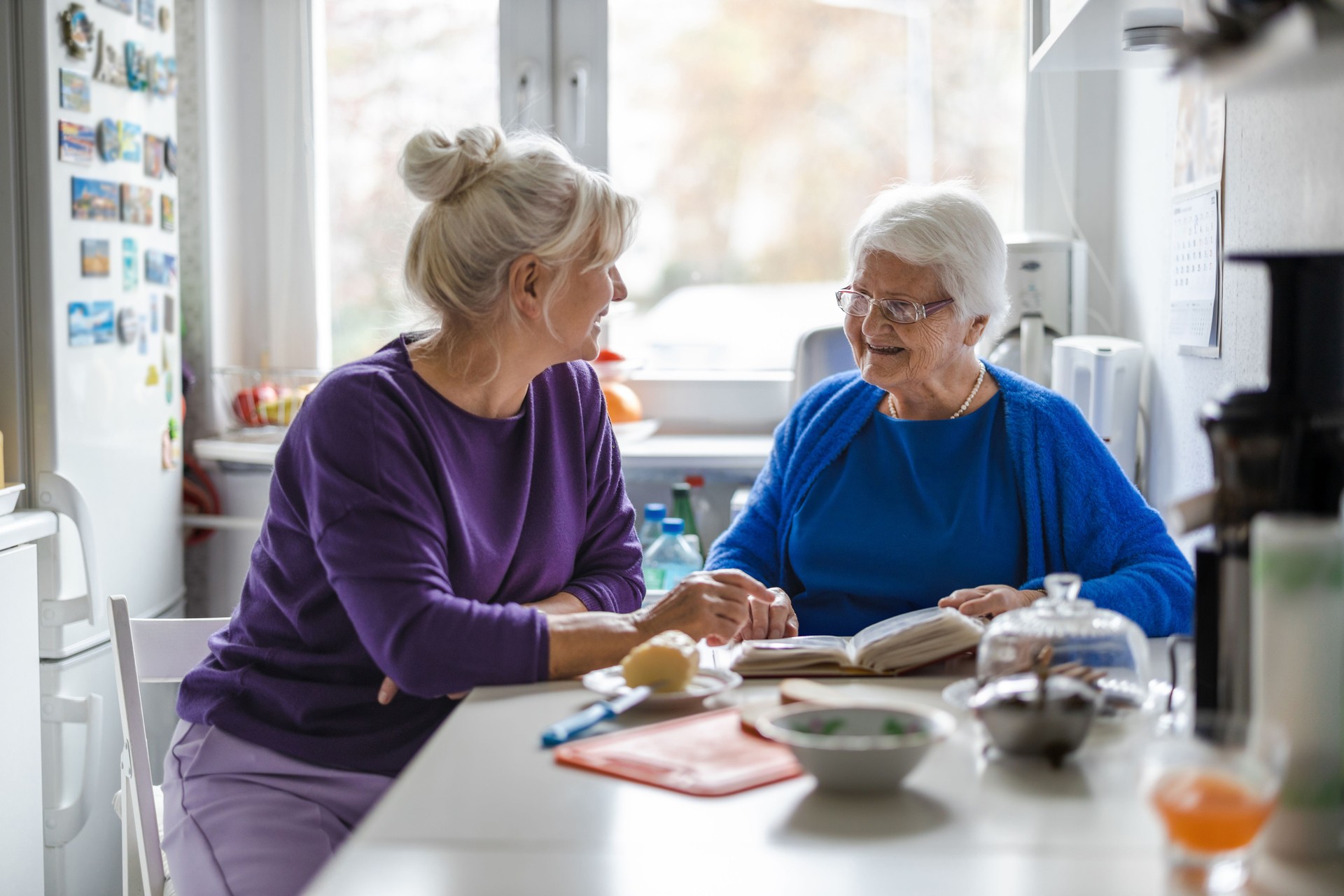 Woman spending time with her elderly mother at home